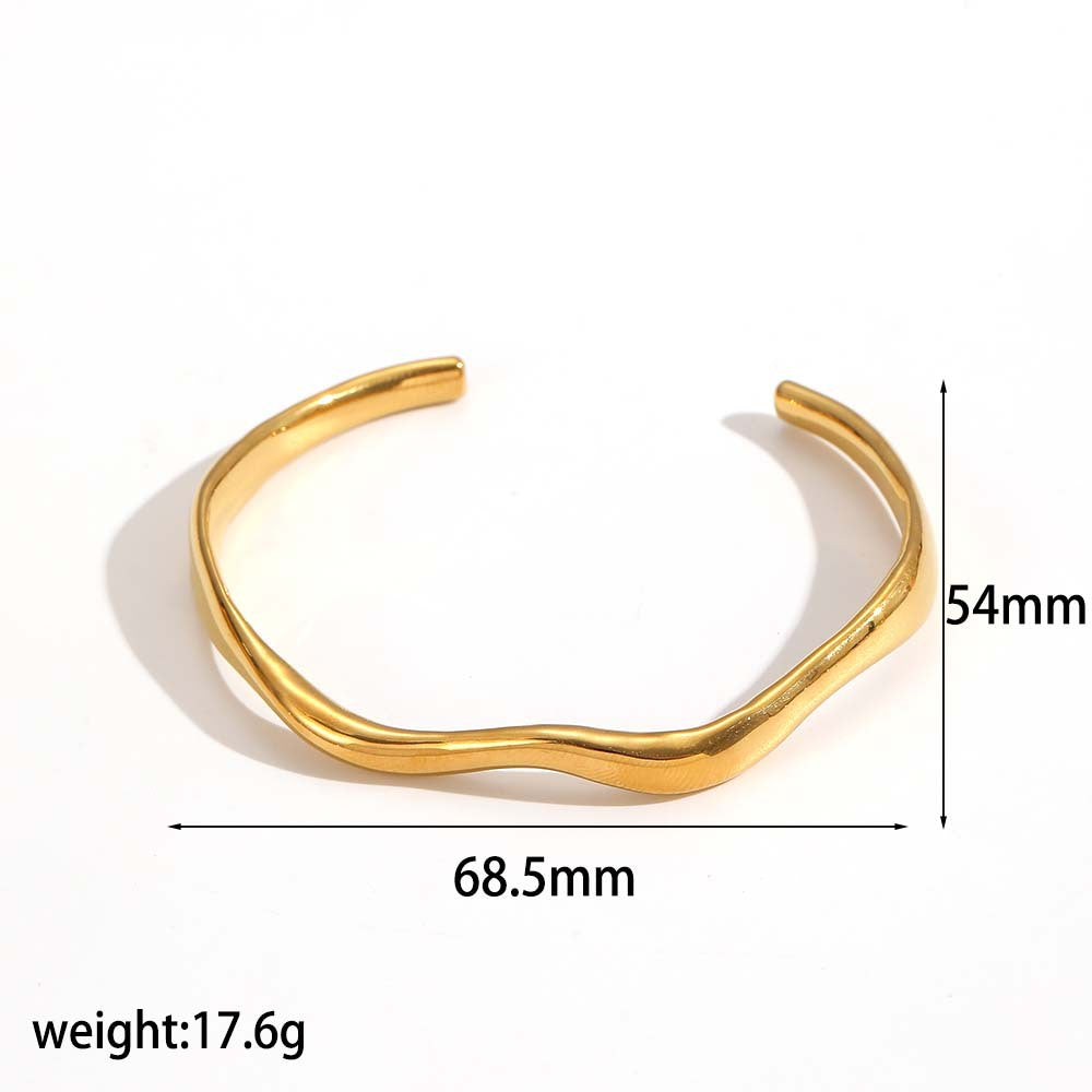 Irregular open cuff bracelet in stainless steel – styled with other jewelry